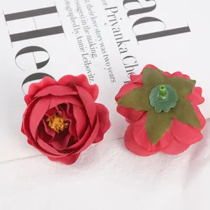 Artificial fabric rose flower head detail, red DIY floral accessory for crafts and wedding decor.