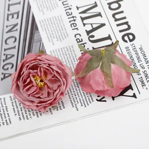 Detailed shot of pink burnt-edge artificial rose flower heads for wedding floral arrangements.