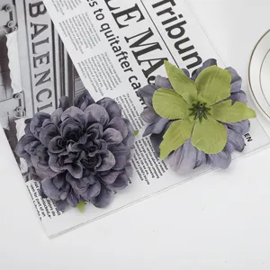 Detail view of artificial peony flower head, silk fabric material in elegant grey-purple tone.