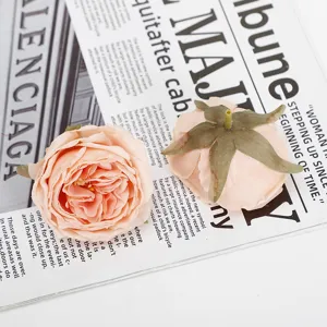 Artificial burnt-edge rose flower heads for wedding decoration and floral arrangements.