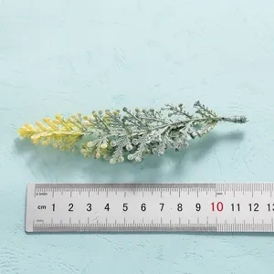 Artificial plant leaf foliage decoration close up view with measuring ruler detail