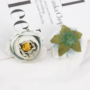 Detailed view of artificial silk rose flower heads, fabric floral DIY craft supplies.