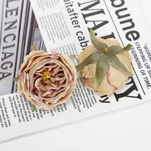 Close-up detail of artificial burnt-edge rose flower heads showcasing vintage petal layers.