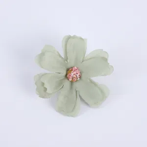 Artificial fabric flower head DIY craft light green decorative floral accessory detail shot