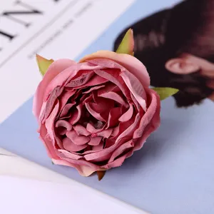 Macro detail shot of artificial pink rose flower head silk material for wedding decor prop.