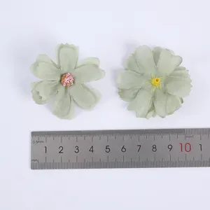 Detail shot of light green multi-layer DIY silk flower heads for wedding decor and crafts.