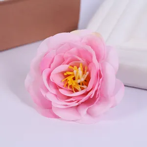 Artificial rose head detail for home decoration, wedding props, pink silk flower piece.