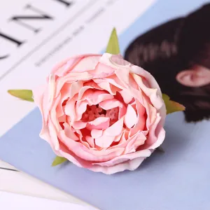 Close-up detail of artificial pink rose flower head, silk floral prop for home and wedding decor.