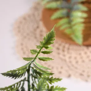 Primer plano detalle de hoja de helecho artificial, textura realista para fotografía.