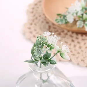 Primer plano detallado de flores blancas artificiales en botella como accesorio.