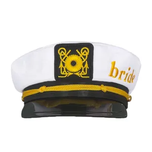 Close-up of a white bridal captain hat featuring golden embroidery "bride" and anchor badge detail.