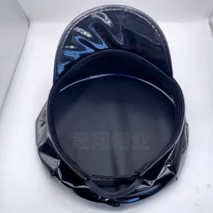 Black patent leather octagonal police hat detail showing inner lining and brim design.