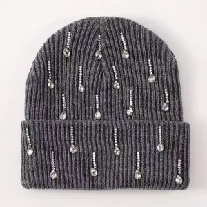 Close-up detail of dark grey ribbed knit beanie decorated with sparkling rhinestone drops.