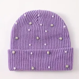 Detail view of women's purple knitted beanie featuring pearl and rhinestone embellishments.