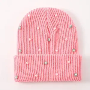 Pink knit beanie hat for women, featuring pearl and rhinestone embellishments for winter warmth.