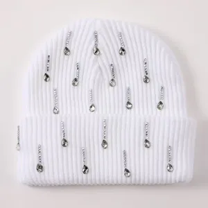 White rhinestone knitted beanie for women, warm winter cap with elegant crystal drop details.