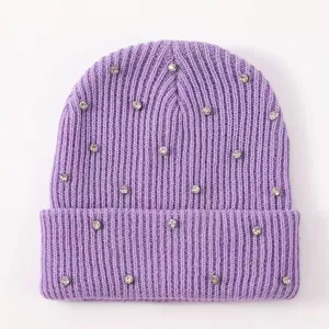 Close-up detail of the sparkling rhinestone embellished purple winter knit beanie hat.