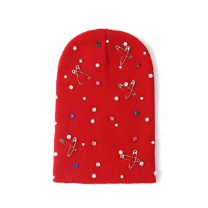 Red knit beanie hat with safety pins and rhinestones, warm winter fashion casual headwear