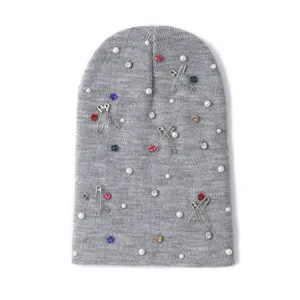 Grey knit beanie with pearls and safety pins, stylish winter warm casual pull-on hat.