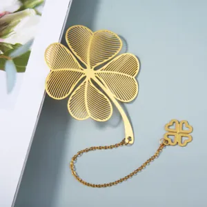 Elegant golden metal hollow four-leaf clover bookmark with delicate chain detail.