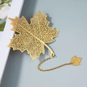 Exquisite gold metal hollow maple leaf bookmark detail view with delicate chain pendant.