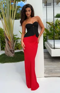 Elegant black strapless top paired with a striking red maxi skirt, perfect for summer chic.