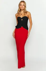 Detailed view of women's black strapless tube top and elegant red slim long maxi skirt.