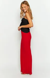 Detailed shot of the elegant black and red two-tone maxi dress outfit, showing flowy fabric.