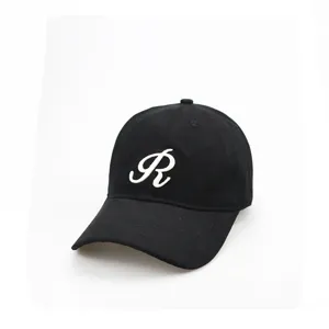 Close-up view of a classic black cotton baseball cap with white embroidered script R logo.