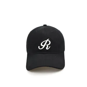 Detailed close-up view of the black cotton baseball cap showcasing white cursive R embroidery.