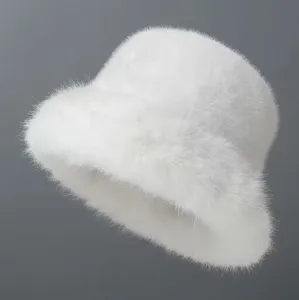 Close-up detail of the soft white plush faux fur texture on a cozy winter bucket hat.