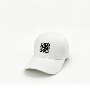 White baseball cap featuring black 3D embroidery monogram design on front panel.