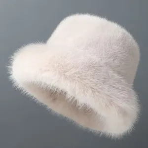Close-up detail of the fluffy faux fur bucket hat, showing soft plush texture and winter warmth.