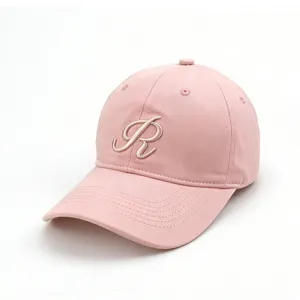 Close-up detail of the pink cotton baseball cap featuring exquisite embroidered letter R and curved brim.