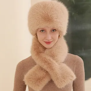 Close-up detail of fluffy faux fur hat and matching winter scarf set in warm camel tone.