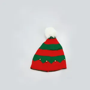 Christmas red green striped knitted hat with white pom pom and golden bells for winter.