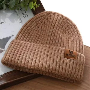 Cozy brown ribbed knit beanie with leather patch, stylish winter warm cap for women and men.