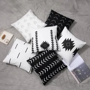 Close-up view of black and white geometric pattern cushion covers, nordic style decor.