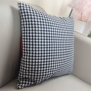 Close-up detail of the black and white houndstooth velvet cushion sofa pillow decoration.