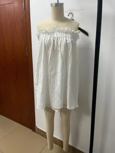 Detail shot of white strapless linen top and skirt set, perfect for summer casual resort wear.