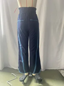 Gedetailleerd overzicht van dames casual losse trekkoord broek met contrastbies.