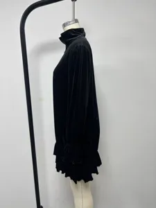 Detail view of black velvet mini dress with stand collar, half zip and ruffle long sleeves.