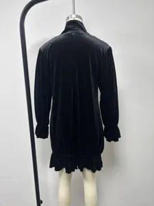 Back detail view of a black crystal velvet mini dress featuring mock neck and ruffled sleeves.