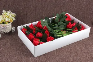 Detailed view of artificial red soap rose bouquet in white box, ideal for home and wedding decor.