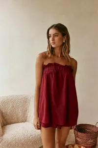 Detailed view of the stylish red linen-blend strapless top and matching shorts set.