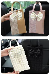 Car tissue box hanging storage bag with bow for auto interior decoration and seat back organization.