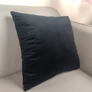 Black velvet throw pillow detail view, soft couch cushion with hidden zipper for living room.