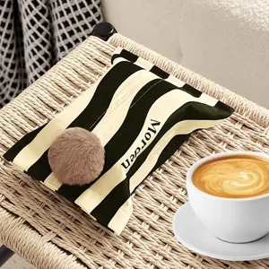 Modern striped tissue box cover with plush ball, stylish home decor for living room.