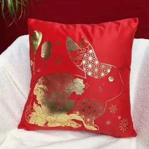 Close-up of Chinese New Year red plush throw pillow cover with elegant gold rabbit pattern details