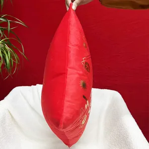 Details of the red plush cushion cover with festive gold stamping for home decoration.